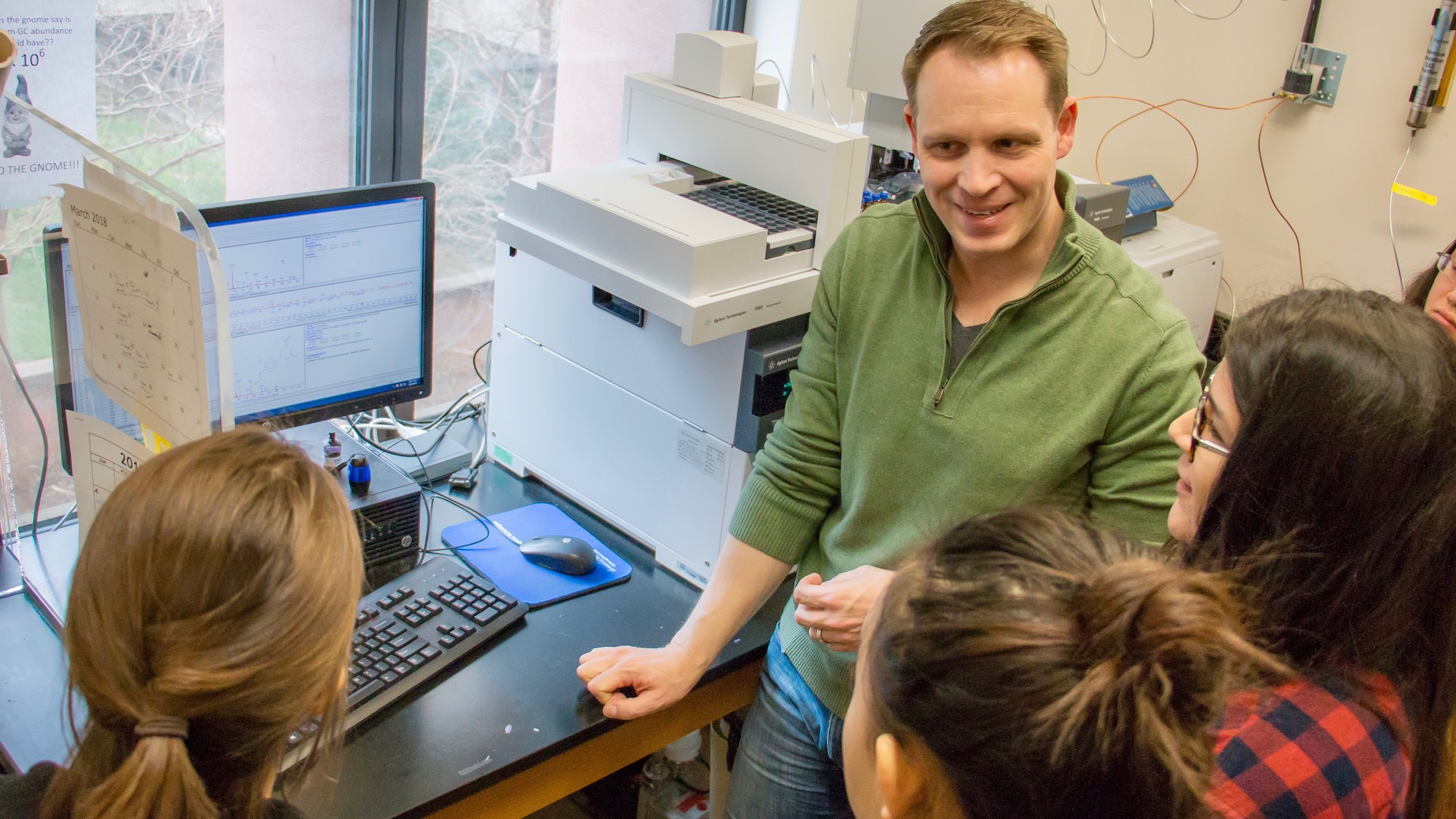 Zerbe stands with students in his lab