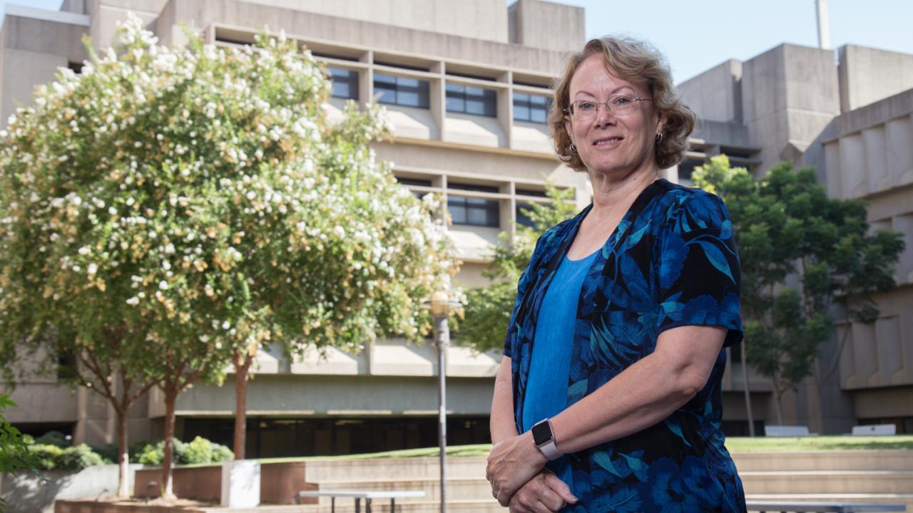 Michele Igo stands in the courtyard outside the Life Sciences Building