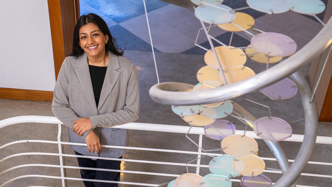 Amrit Bains in stairwell next to DNA helix sculpture