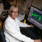 Mark Huising sits at lab bench