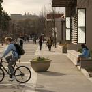 Student on bike outside Walker Hall