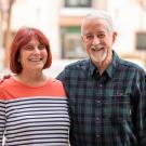 Tammy and Steve Conston standing outside the Green Hall courtyard with Esau Hall behind them. 