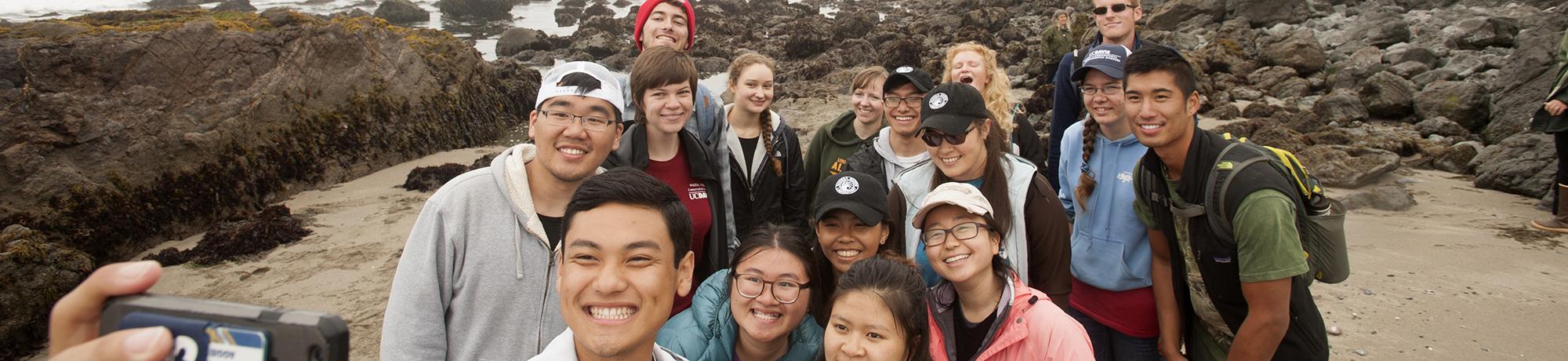 Students taking a selfie on the coastline